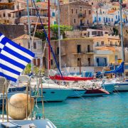 Blue white Greek flag on wind in Greece port, Kos
