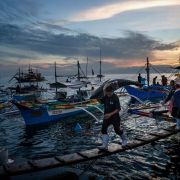 Pracownik niesie złowionego tuńczyka żółtopłetwego w porcie rybackim General Santos, uważanym za stolicę tuńczyka na Filipinach