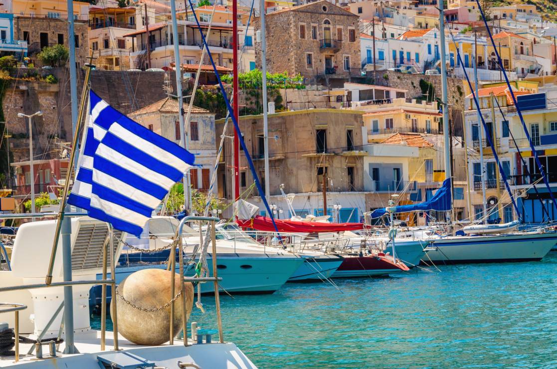 Blue white Greek flag on wind in Greece port, Kos